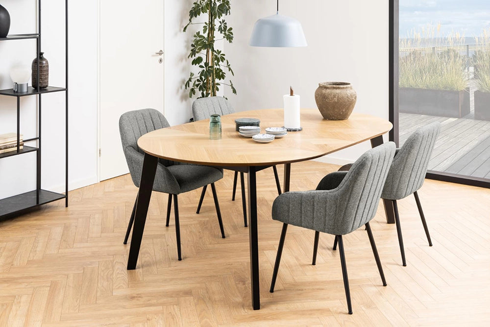 Mahon Extending Dining Table in Matte Oak Finish with Grey Chair and Indoor Plant in Dining Room Setting
