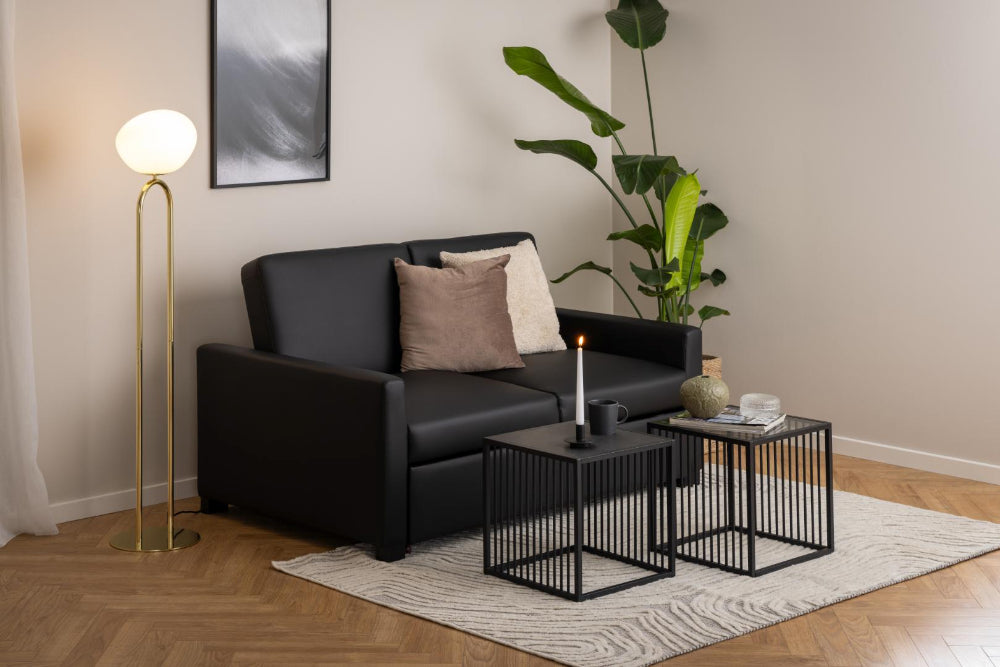 Melanie Glass Top Side Table with Gold Floor Lamp and Indoor Plant in Living Room Setting