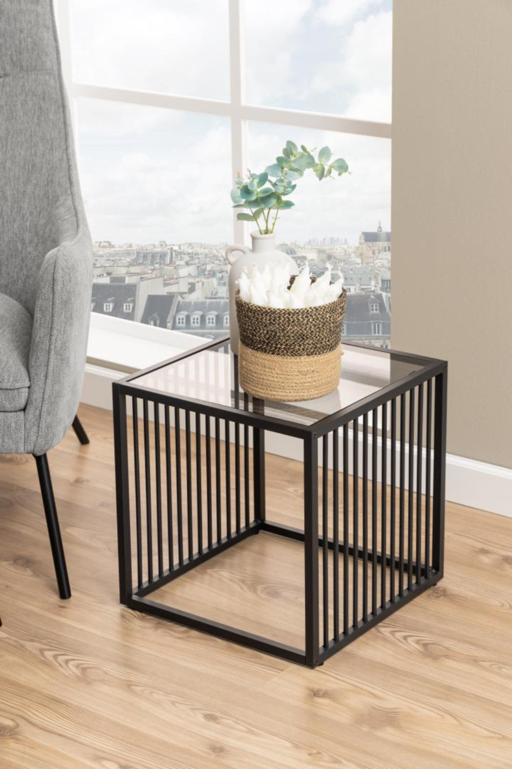 Melanie Glass Top Side Table with Lounge Chair and Flower Vase in Living Room Setting