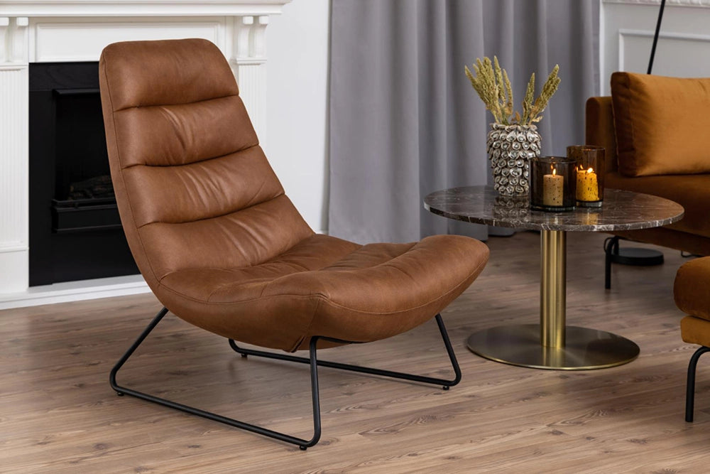 Mindy Lounge Chair in Brandy Finish with Coffee Table and Glass Candle in Living Room Setting