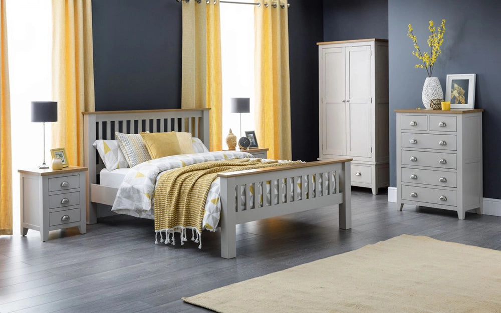 Monde 6 Drawer Wide Chest Ass in Oak Finish with Wooden Wardrobe and Table Lamp in Bedroom Setting