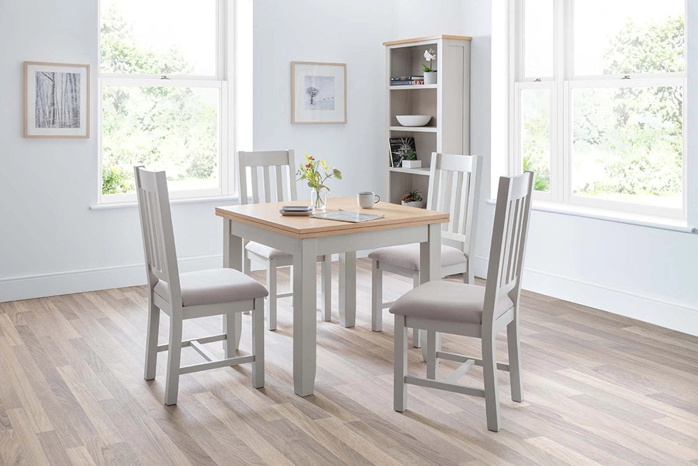 Monde Extending Dining Table in Oak Finish with Wooden Chairs and Shelves in Breakout Setting