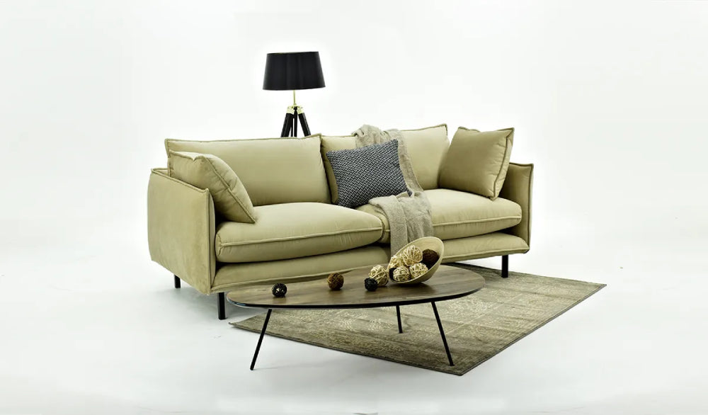 Noah 3 Seater Sofa in Olive Finish with Coffee Table and Floor Lamp in Studio Setting