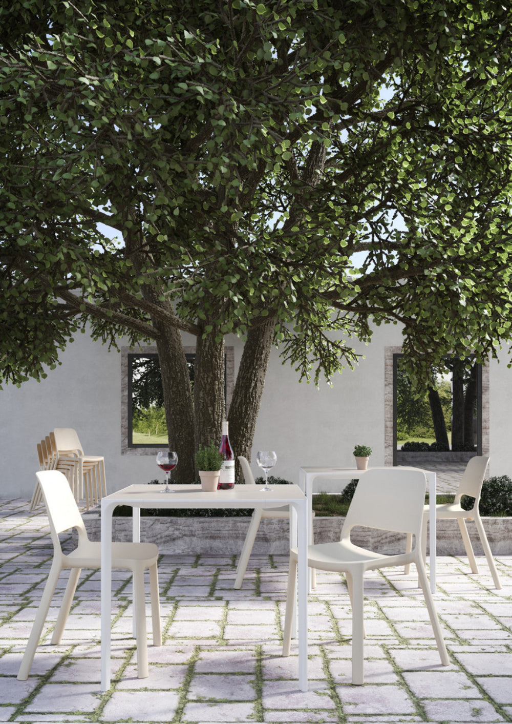 Nuke Polypropylene Outdoor Chair in White Finish with Square Table in Outdoor Setting