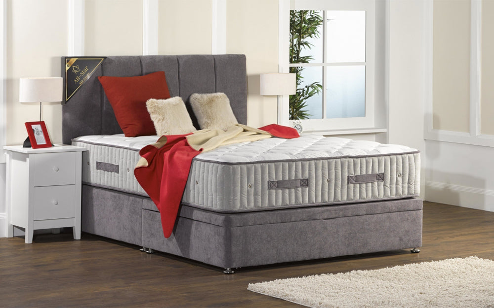 Ottoman Bed Close View in Grey Finish with Red Blanket and Pillow in Bedroom Settings