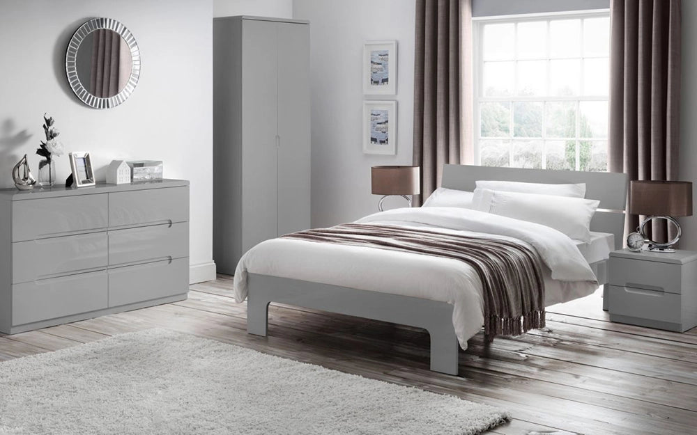 Parker 6 Drawer Wide Chest in Grey Finish with Wardrobe and Brown Lampshade in Bedroom Setting