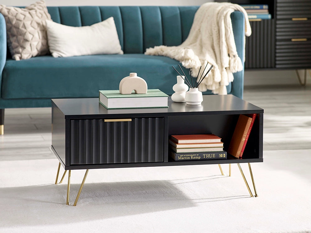 Range Coffee Table in Matte Black Finish with Upholstered Sofa and Pillow in Living Room Setting