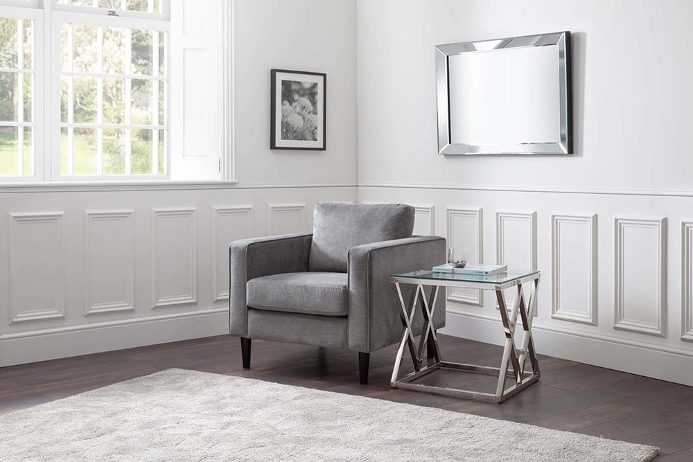 Ritz Glass Top Lamp Table with Upholstered Grey Armchair and Wall Frame in Living Room Setting