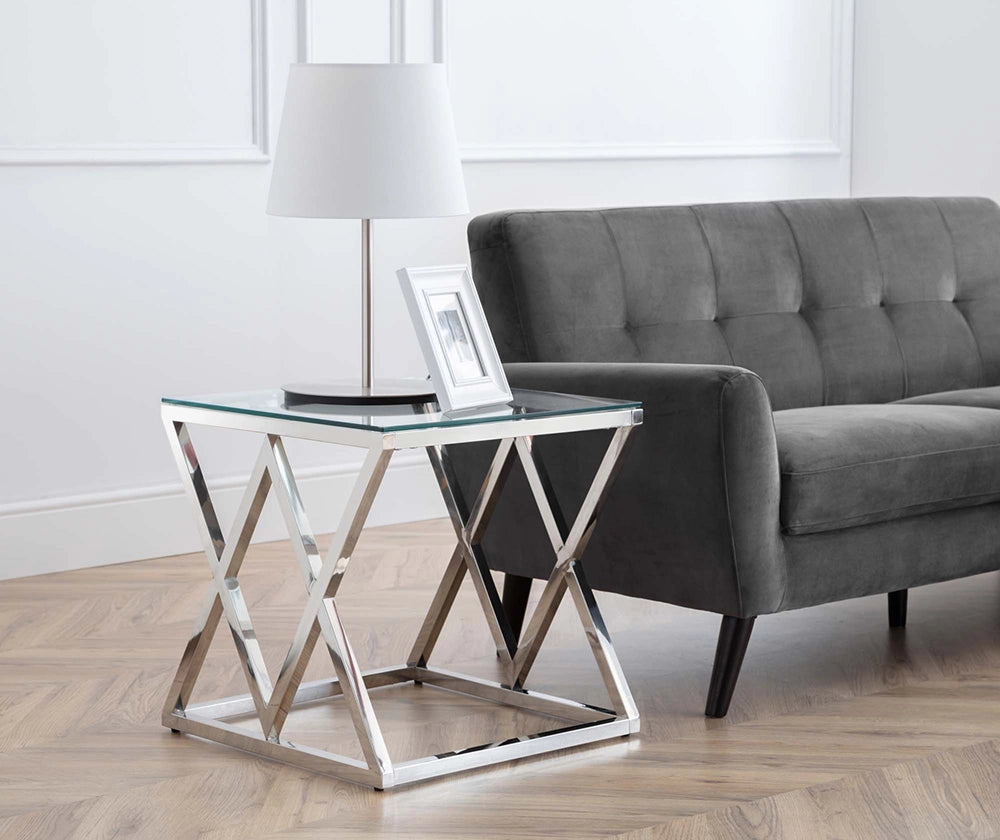 Ritz Glass Top Lamp Table with White Table Lamp and Upholstered Grey Sofa in Living Room Setting