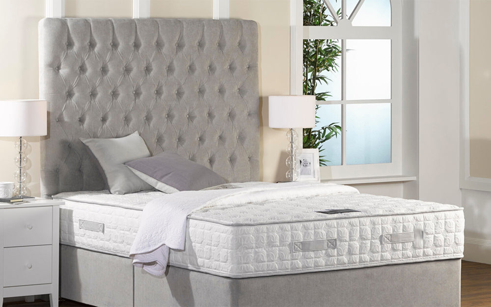 Riveria DB Headboard 66" High in Grey Finish with Pillows and Bedside Cabinet in Bedroom Setting