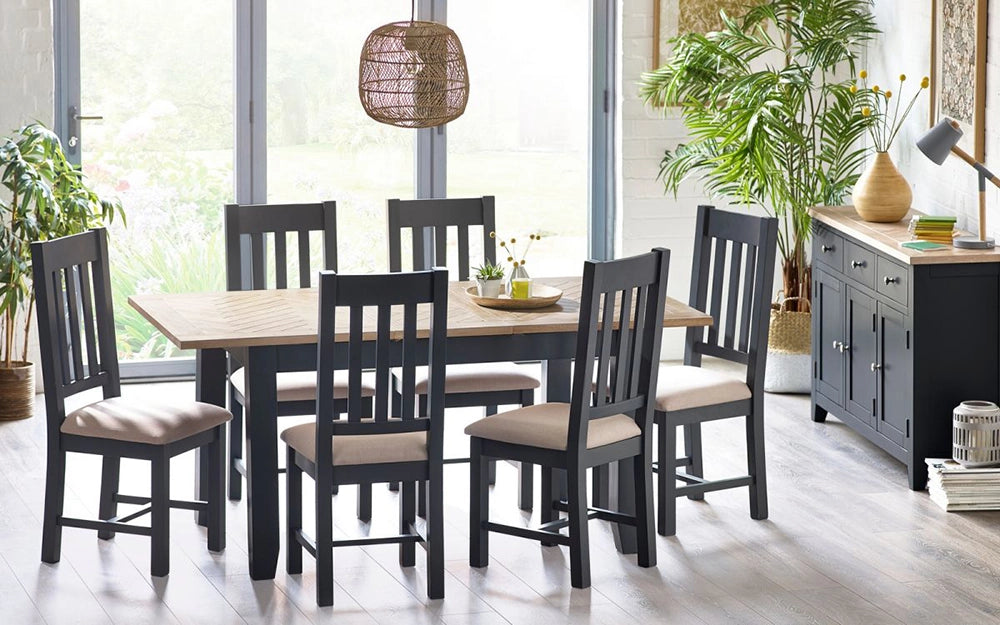 Rua Extending Dining Table Dark Grey Leg Finish with Two Toned Finish Cupboard and Indoor Plant in Dining Setting