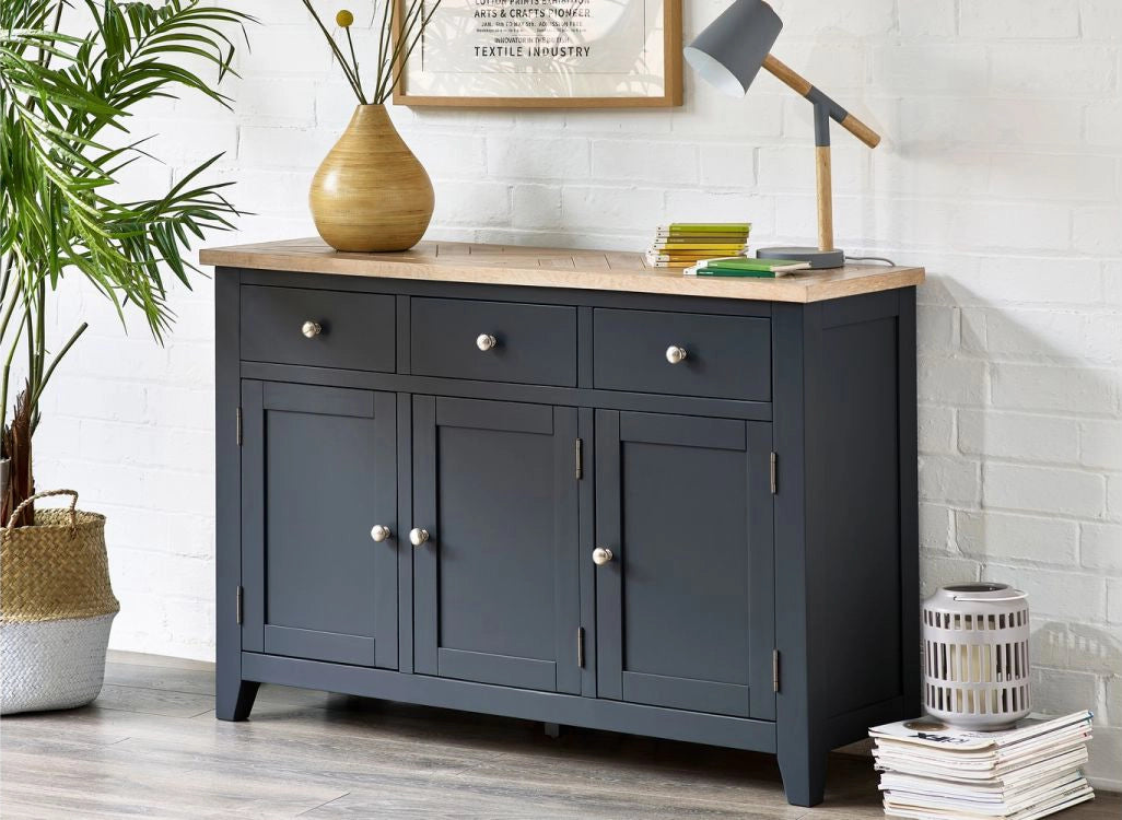 Rua Sideboard in Dark Grey Finish with Bunch of Magazines and Wooden Lamp in Office Setting