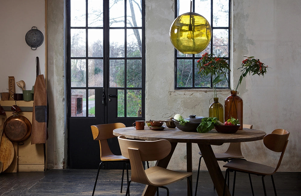 Sculpt Dining Chair Brown with Round Dining Table and Hanging Lighting in Kitchen Setting