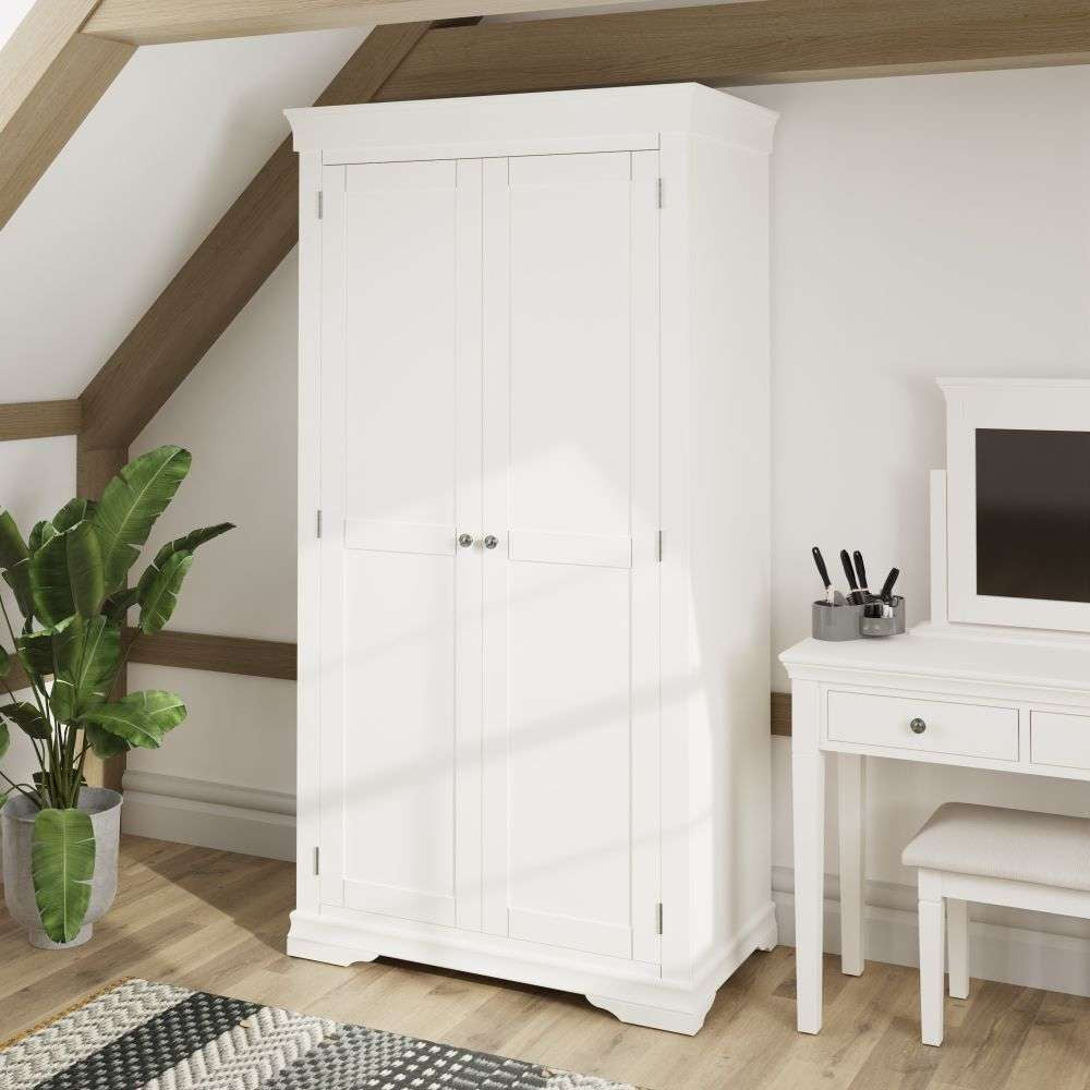 Shelby Full Hanging Wardrobe in White Finish with Vanity Table and Indoor Plant in Bedroom Setting