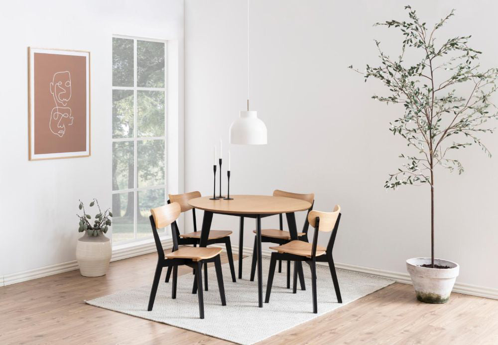 Sierra Round Dining Table Oak and Black with Indoor Plant and Chair in Dining Setting