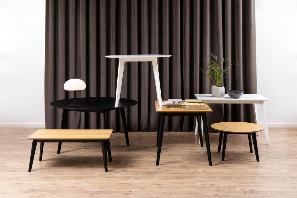 Sierra Round Dining Table in Black Finish with Coffee Table and Plant in Breakout Setting