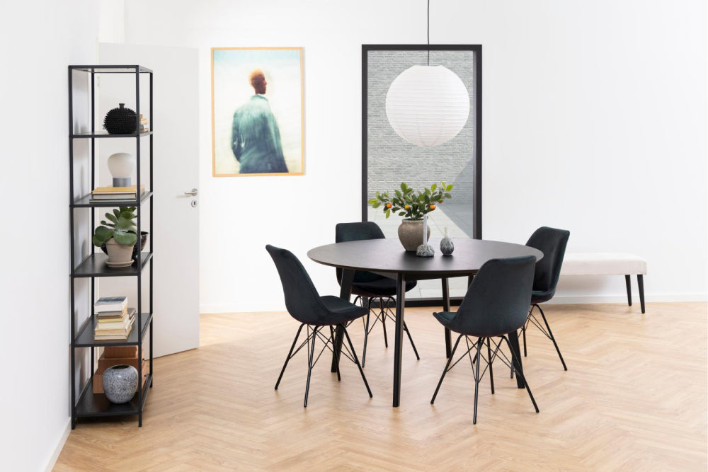 Sierra Round Dining Table in Black Finish with Dining Chair and Bookshelves in Living Room Setting