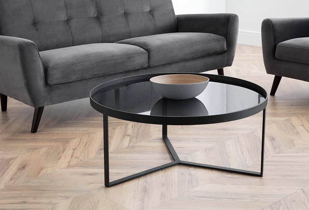 Skylar Coffee Table Smoked Glass with Upholstered Grey Sofa and Bowl in Living Room Setting