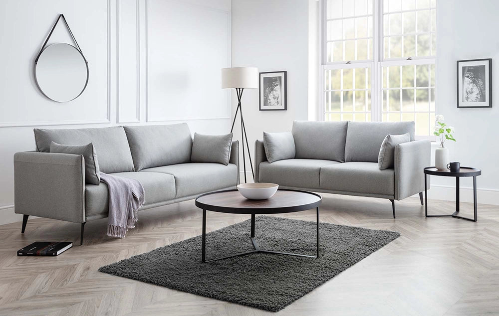 Skylar Coffee Table in Walnut Finish with Upholstered Grey Sofa and Wall Frame in Living Room Setting