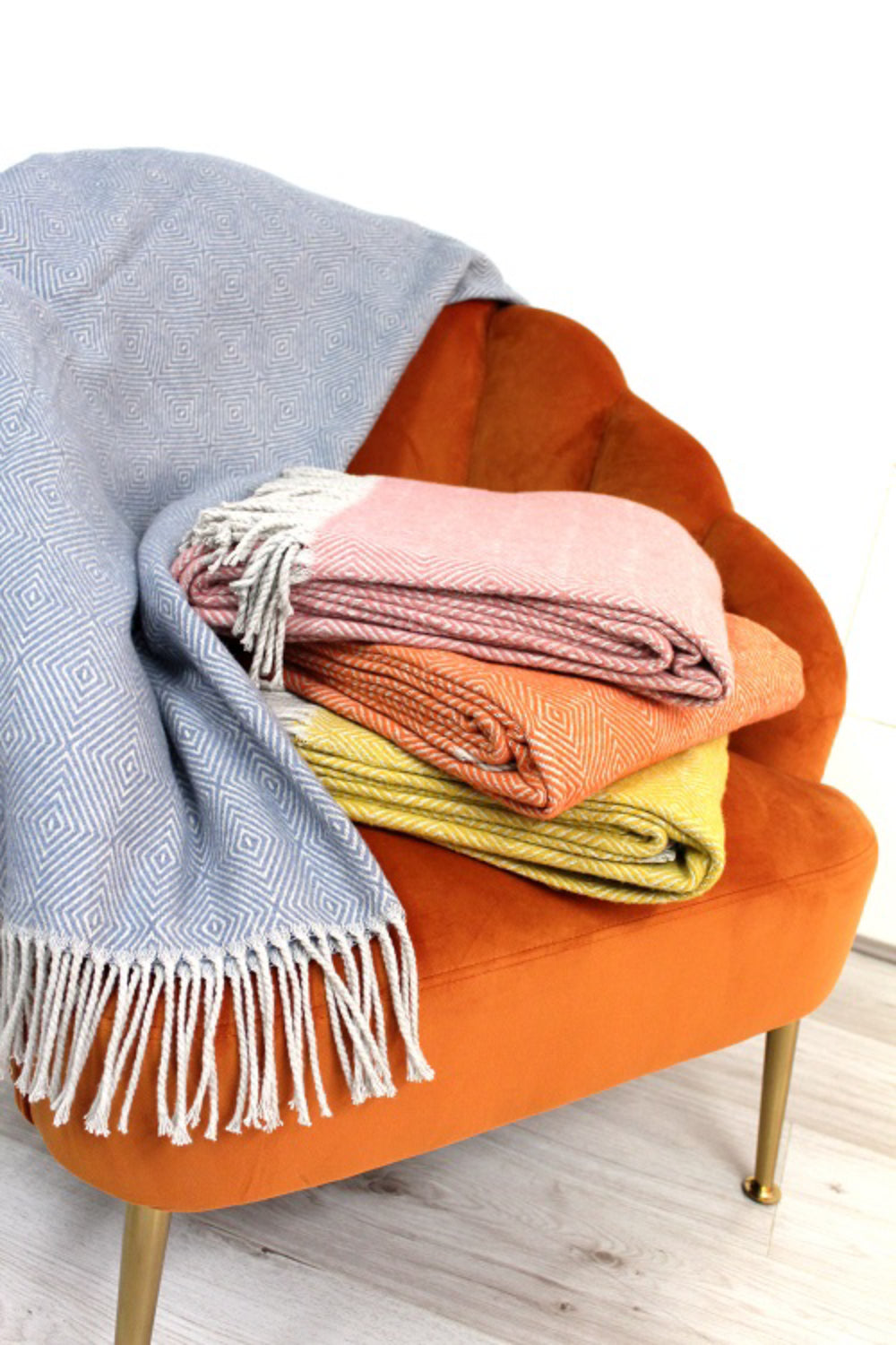 Soft Fringed Knitted Throw with Upholstered Lounge Chair