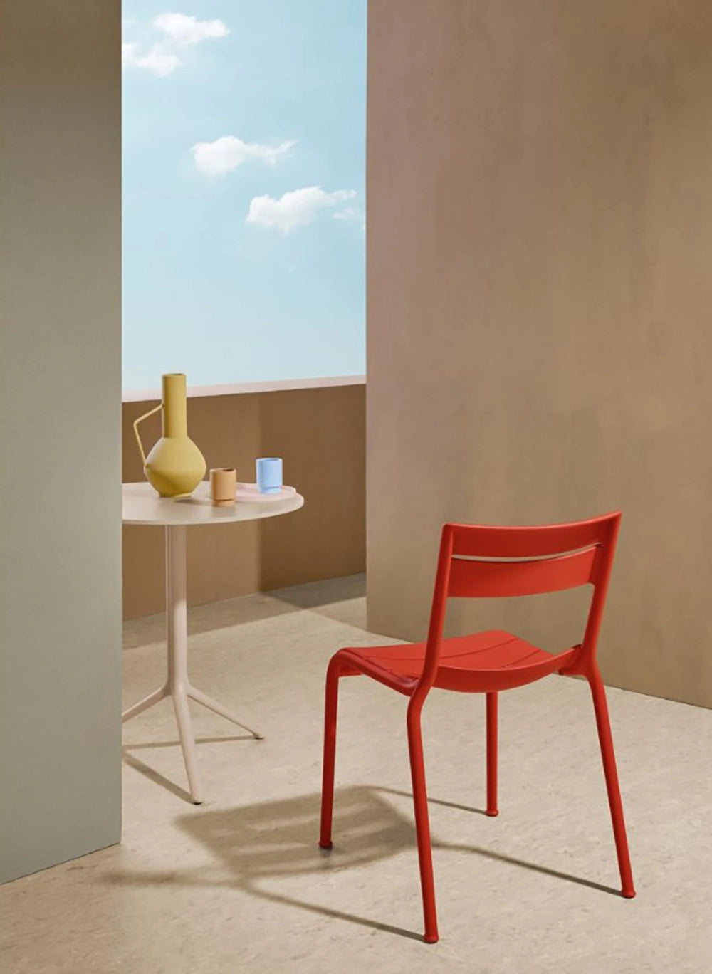 Souvenir Dining Chair in Red Finish with Round Table in Outdoor Setting