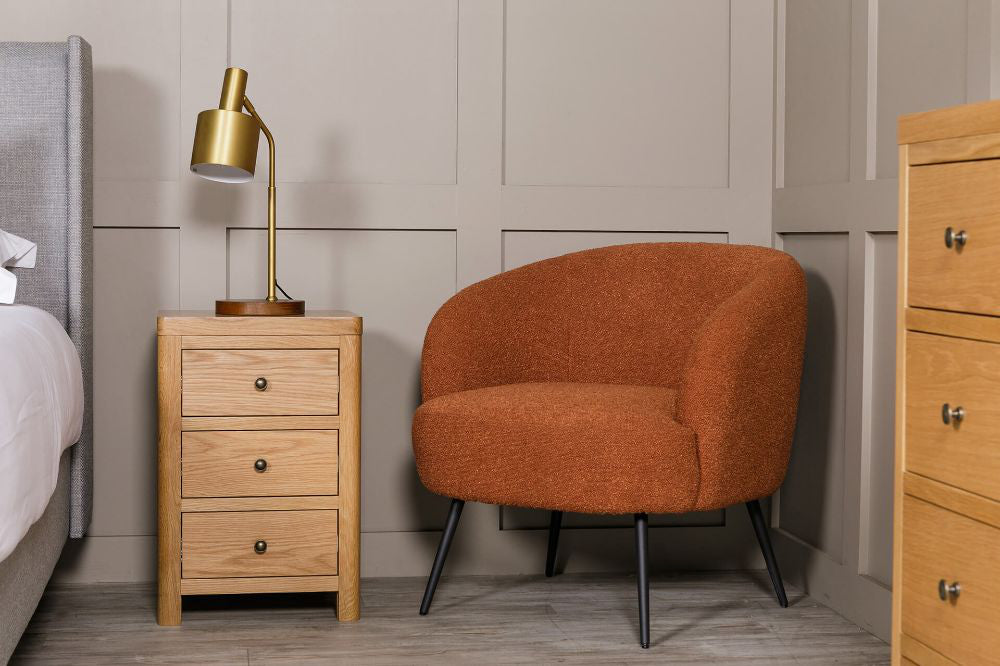 Spencer Accent Chair in Rust Finish with Side Table and Lampshade in Bedroom Setting