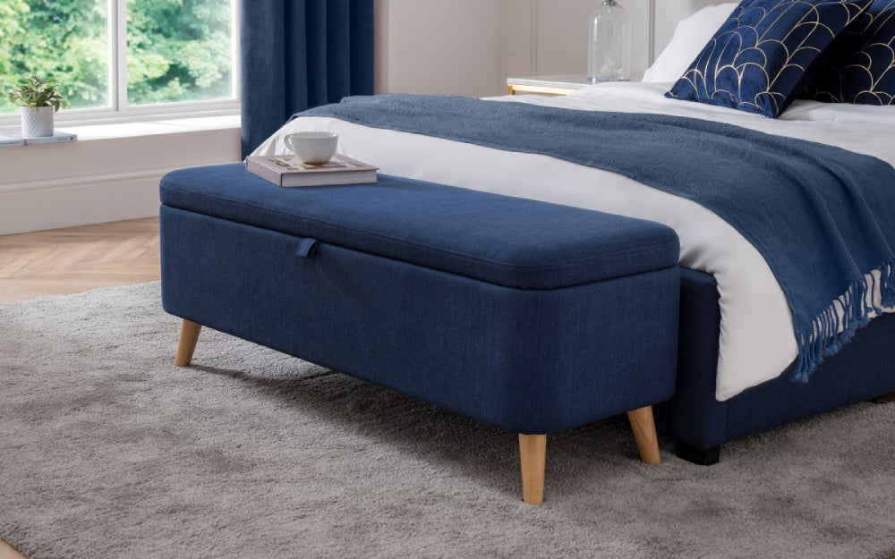 Stellar Upholstered Blanket Box in Blue Finish with Throw and Cushion in Bedroom Setting