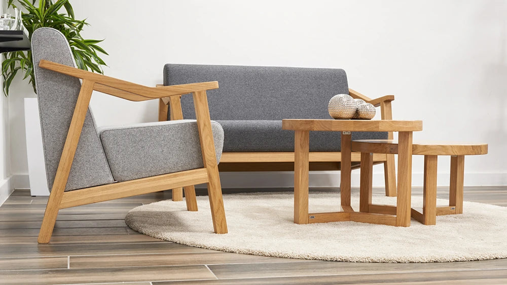 Strut 2 Seater Sofa in Light Grey Finish with Round Coffee Table and White Plant Pot in Living Room Setting