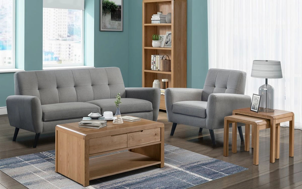 Vault Oak Coffee Table with Grey Upholstered Armchair and Sofa in Living Room Setting