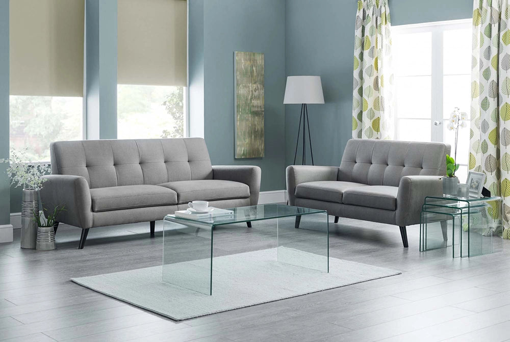 Venice Bent Glass Coffee Table with Standing Lamp and Upholstered Grey Sofa in Living Room Setting