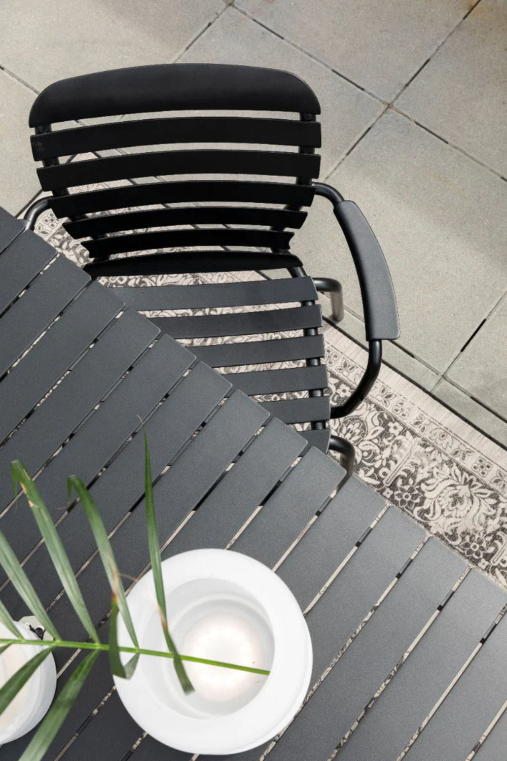 Vera Outdoor Armchair in Black Finish with Table in Outdoor Setting