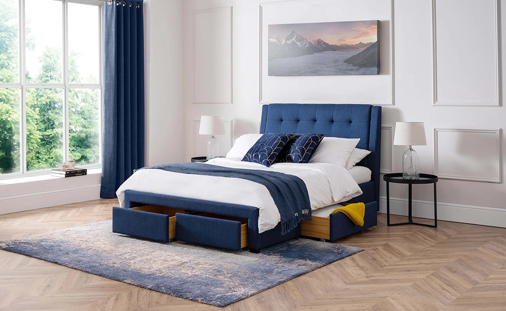 Violet 4 Drawer Bed in Blue Finish with White Lamp Shade and Painting in Bedroom Setting
