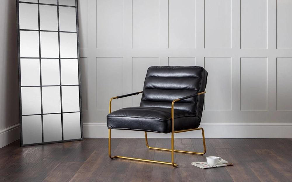 William Black Leather Accent Chair with White Cup and Newspaper in Living Room Setting