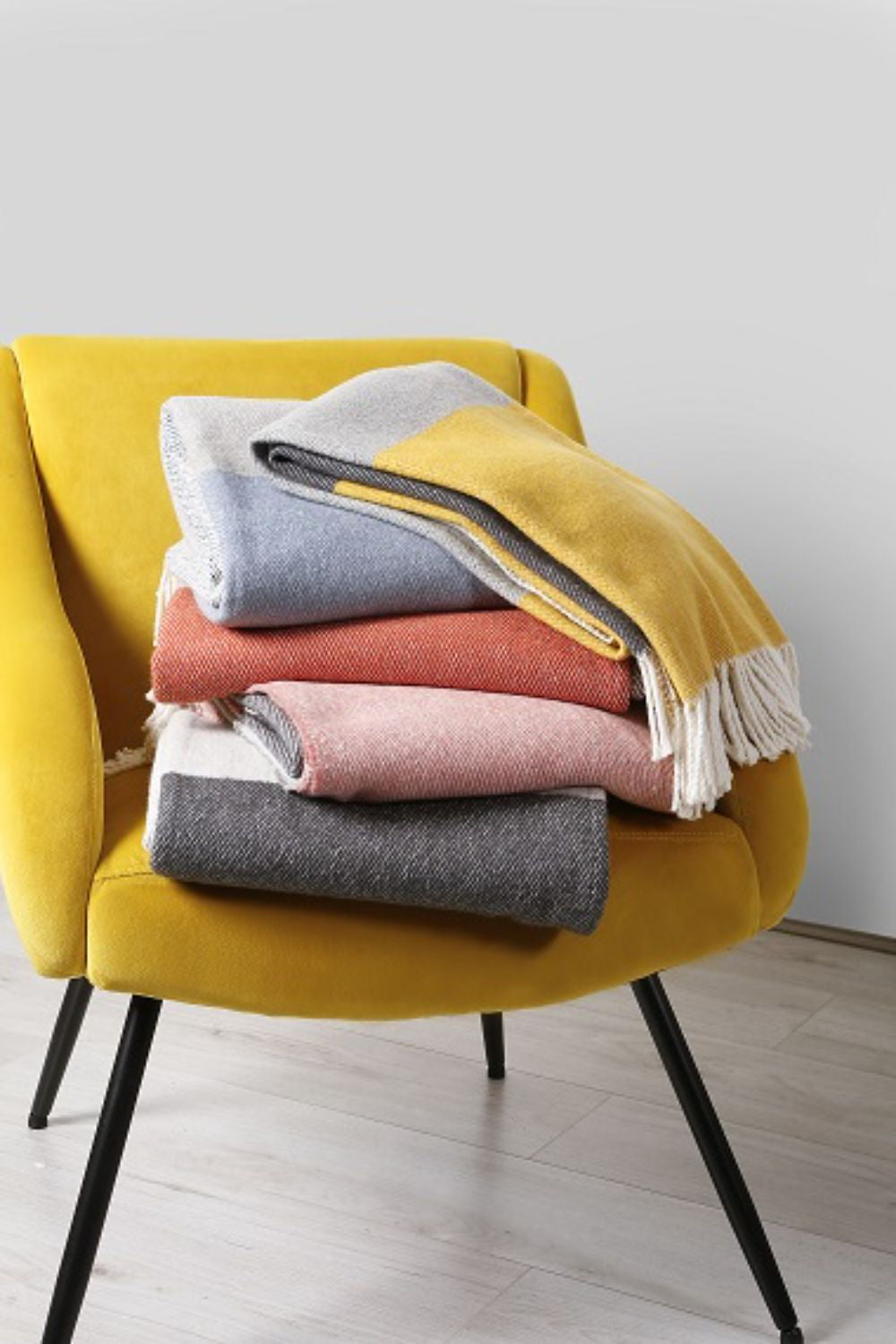 Yellow Lounge Armchair with Stellar Fringed Throw in Living Room Setting